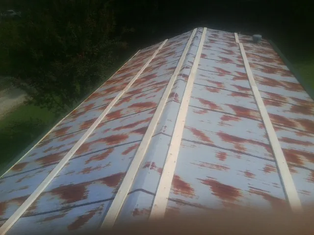 Rusted metal roof panels with new wood purlins before replacement — Storm Damage Roof Repair in La Puente by Roofing Brothers